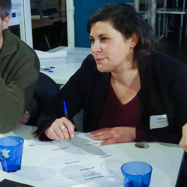 3 personnes en train de discuter autour d'une table